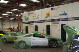 Car respraying - Vehicles waiting to enter the Spraybooths